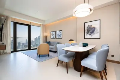 a living room with a table and chairs at Escape24 2BR in Address Opera with Skyline Views near Burj Khalifa in Dubai