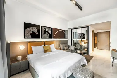a bedroom with a large bed and a living room at Studio MAG 318 City View Business Bay in Dubai