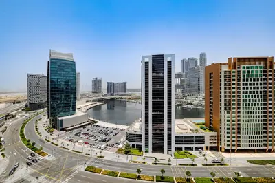 a city skyline with tall buildings and a river at Studio MAG 318 City View Business Bay in Dubai