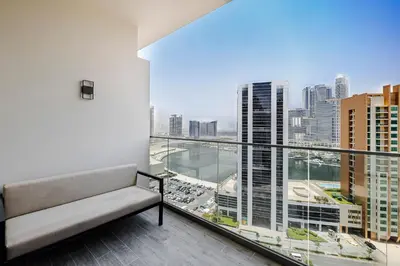 a balcony with a couch and a view of the city at Studio MAG 318 City View Business Bay in Dubai