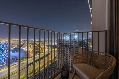 a balcony with a chair and a view of a city at GuestReady - Sky-High Comfort at Dubai Hills in Dubai