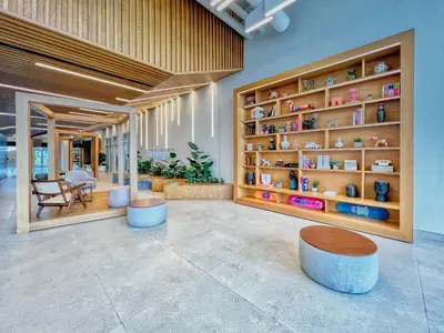 a lobby with tables and shelves of vases at GuestReady - Sky-High Comfort at Dubai Hills in Dubai