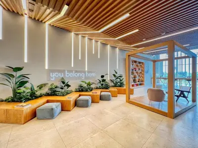 a lobby with couches and plants in a building at GuestReady - Sky-High Comfort at Dubai Hills in Dubai