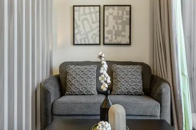 a living room with a couch and a table at Studio Retreat with Canal and Burj Khalifa Views in Dubai