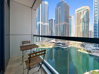 a balcony with a view of the water in a city at StoneTree - Stunning Lake View - Spacious in Dubai