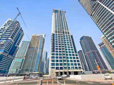 a group of tall buildings in a city at StoneTree - Stunning Lake View - Spacious in Dubai