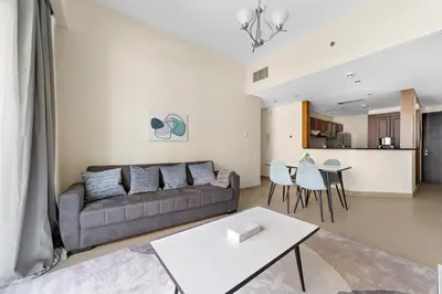 a living room with a couch and a table at StoneTree - Stunning Lake View - Spacious in Dubai