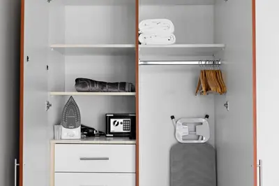 a closet with white shelves and a suitcase at StoneTree - Stunning Lake View - Spacious in Dubai