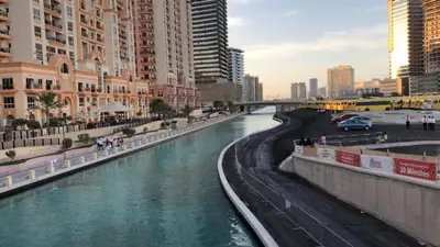 a river in the middle of a city with tall buildings at Stylish Studio Urban Retreat in Dubai