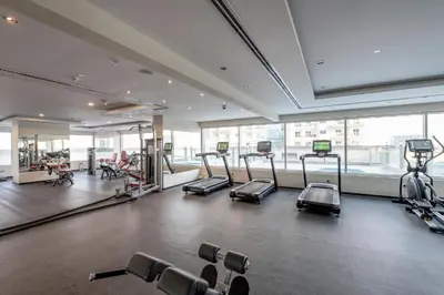 a gym with cardio equipment in a large room at Stylish Studio Urban Retreat in Dubai