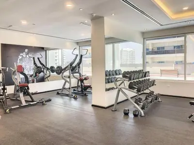 a gym with treadmills and exercise equipment in a building at Stylish Studio Urban Retreat in Dubai