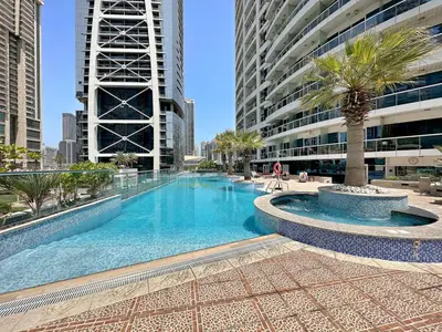 a swimming pool in the middle of a building at StoneTree - Cozy 1 BR - Near Metro in Dubai
