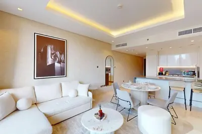 a living room with a white couch and a table at The Sterling - Modern One Bedroom in Dubai