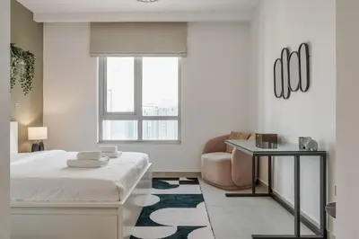 a bedroom with a bed and a couch and a chair at Prime Downtown 2BR Retreat in Dubai