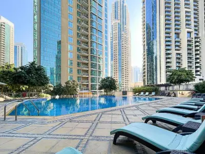a swimming pool in a city with tall buildings at Prime Downtown 2BR Retreat in Dubai