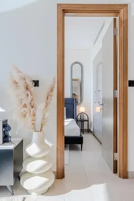 a bedroom with a vase and a bed with a mirror at Sobha waves I Cozy 1BDR I Burj Khalifa View in Dubai