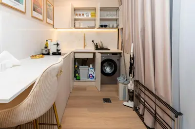 a laundry room with a washer and a washing machine at Upgraded Designer-crafted Studio in JVC with Massive Terrace in Dubai