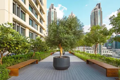 a park with benches and trees and buildings at Elite Royal Apartment - Sky Series - Full Panoramic Burj Khalifa & Fountain View - Icon in Dubai