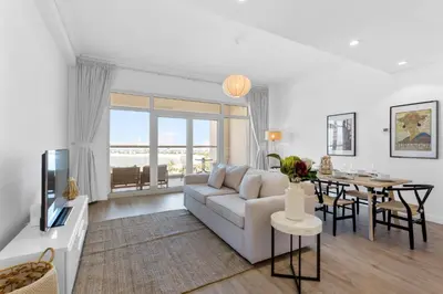 a living room with a couch and a table at Exquisite 1BR with Private beach in Palm Jumeirah in Dubai