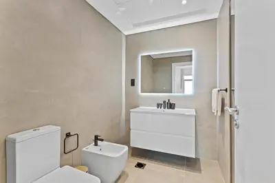 a bathroom with a white toilet and a sink at Exquisite 1BR with Private beach in Palm Jumeirah in Dubai