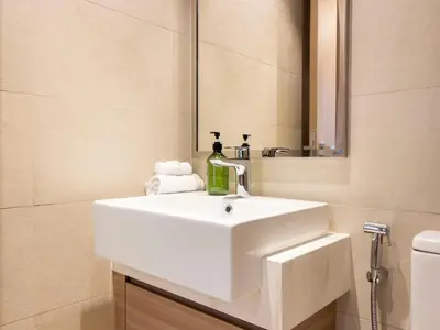 a bathroom with a white sink and a mirror at Spacious 2BR with Big Balcony In Meydan in Dubai