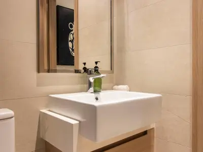 a bathroom with a white sink and a mirror at Spacious 2BR with Big Balcony In Meydan in Dubai