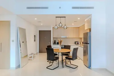 a kitchen and dining room with a table and chairs at New I Modern I 1BDR I 17 Icon Bay Tower 2 in Dubai