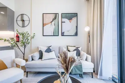 a living room with two couches and a table at Delightful 1BR Apartment in Azizi Riviera 22, Al Merkadh by Deluxe Holiday Homes in Dubai