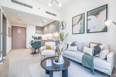 a living room with a couch and a table at Delightful 1BR Apartment in Azizi Riviera 22, Al Merkadh by Deluxe Holiday Homes in Dubai