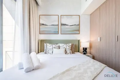 a bedroom with a large white bed with pillows at Delightful 1BR Apartment in Azizi Riviera 22, Al Merkadh by Deluxe Holiday Homes in Dubai