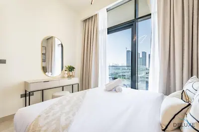 a bedroom with a white bed and a large window at Delightful 1BR Apartment in Azizi Riviera 22, Al Merkadh by Deluxe Holiday Homes in Dubai