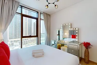 a bedroom with a white bed and a large window at Palace Residences - Inviting One Bedroom in Dubai