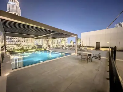 a pool on the roof of a building at Palace Residences - Inviting One Bedroom in Dubai