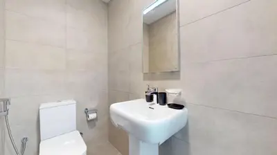 a white bathroom with a sink and a toilet at Locations I Uni Estate Supreme Residence I Luxury 1BR I Near Miracle Garden I Pool, Gym & Parking in Dubai