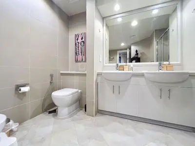 a bathroom with a toilet and a sink and a mirror at Golden Mile 1 - Contemporary One Bedroom in Dubai