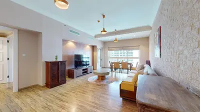 a living room with a couch and a tv at Golden Mile 1 - Contemporary One Bedroom in Dubai