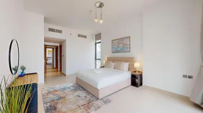 a white bedroom with a bed and a rug at Liv Residences - Spacious Two Bedroom in Dubai