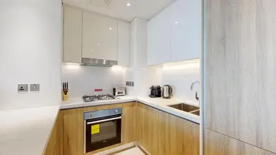 a kitchen with white counters and a stove top oven at Liv Residences - Spacious Two Bedroom in Dubai