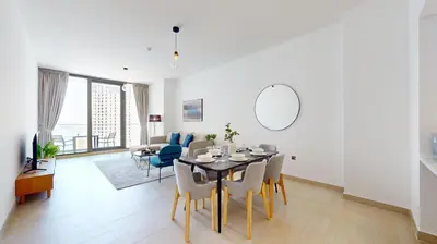 a dining room and living room with a table and chairs at Liv Residences - Spacious Two Bedroom in Dubai