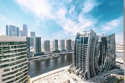 a view of a city with a river and buildings at LUXE | 1BR | Close to Burj Khalifa & Dubai Mall in Dubai