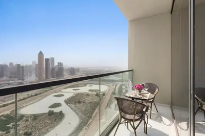 a balcony with a table and chairs and a view at Lush studio with Pool & Dubai Water Canal Views in Dubai