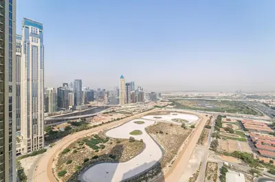 an aerial view of a city with tall buildings at Lush studio with Pool & Dubai Water Canal Views in Dubai