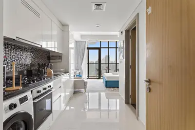 a kitchen with a sink and a stove top oven at Lush studio with Pool & Dubai Water Canal Views in Dubai