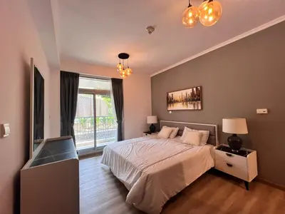 a bedroom with a bed and a large window at Luxurious 1BR in Burj Views Podium, Downtown in Dubai