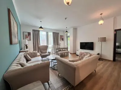 a living room with two couches and a television at Luxurious 1BR in Burj Views Podium, Downtown in Dubai