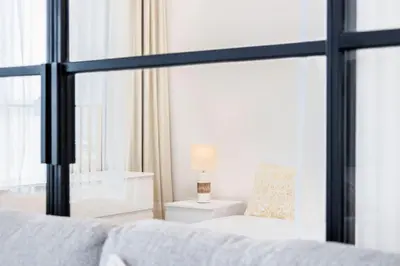 a bedroom with a bed and a window at Socio Tower1 - Dubai Hills Modern Urban Retreat in the City by Serenity Living Holiday Homes in Dubai
