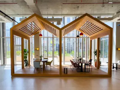 a large wooden structure with tables and chairs in a room at Socio Tower1 - Dubai Hills Modern Urban Retreat in the City by Serenity Living Holiday Homes in Dubai