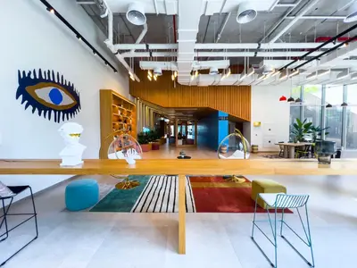 an office with a large wooden table and chairs at Socio Tower1 - Dubai Hills Modern Urban Retreat in the City by Serenity Living Holiday Homes in Dubai