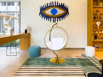 a living room with a mirror and a desk at Socio Tower1 - Dubai Hills Modern Urban Retreat in the City by Serenity Living Holiday Homes in Dubai