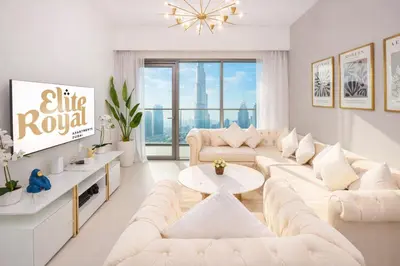 a living room with white furniture and a large window at Elite Royal Apartment - Sky Series - Full Burj Khalifa & Fountain View - Noble in Dubai